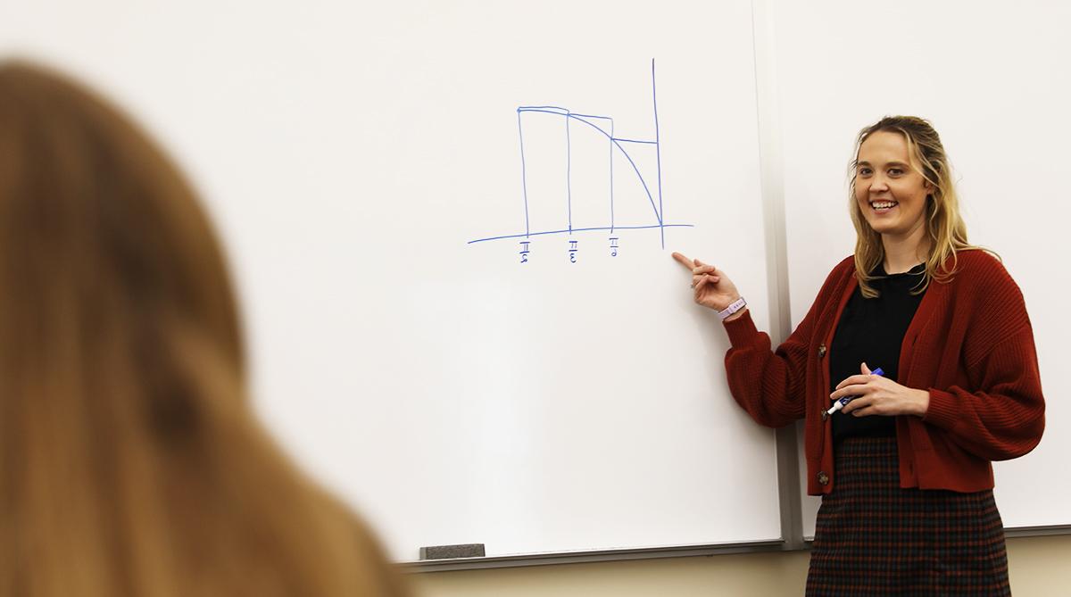 Mathematics professor in front of an equation